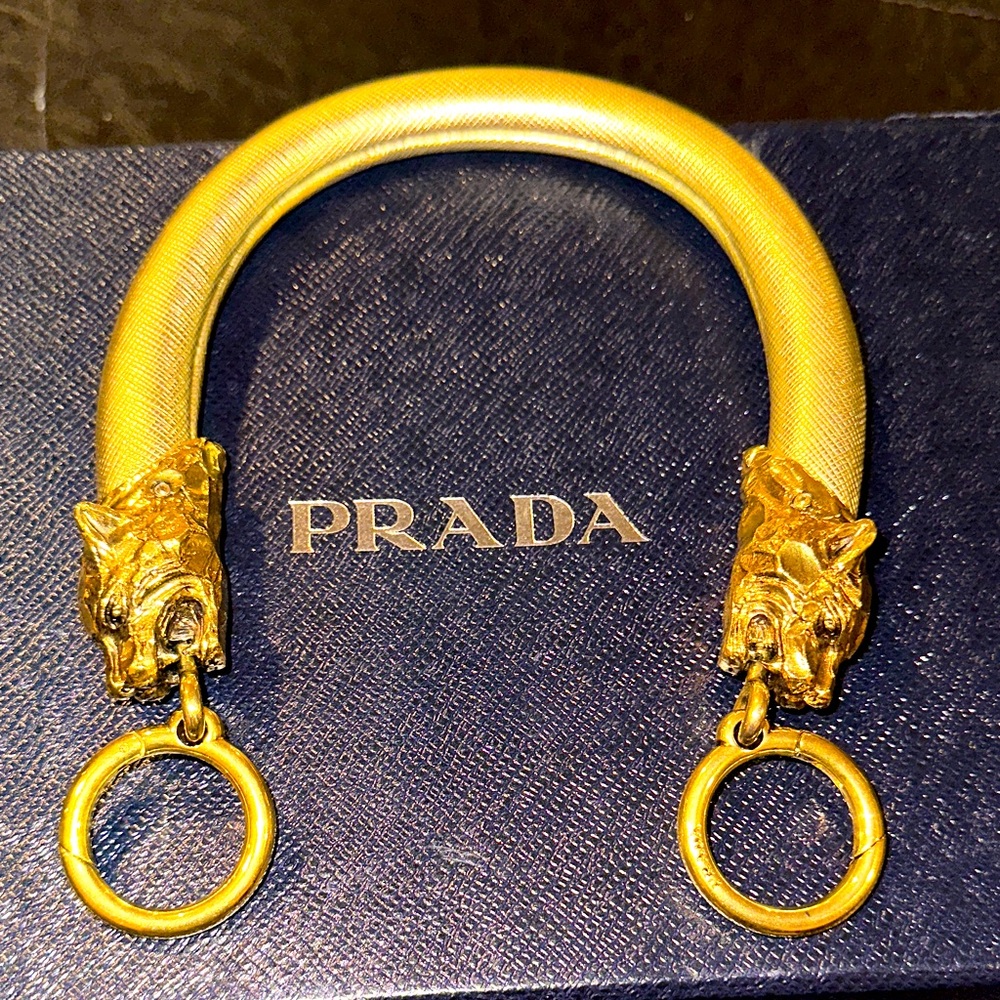 Prada Gold Canine Motif bag handles.